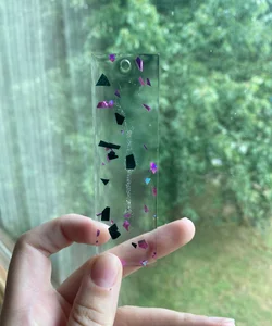 3.81” by 1.81” black and pink foil resin bookmark