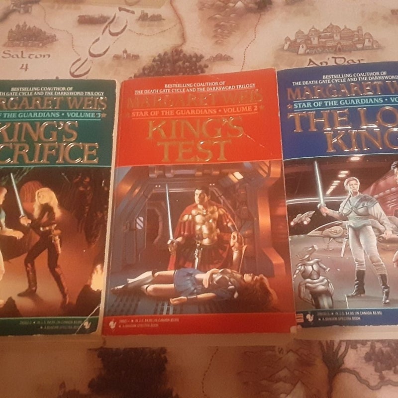 Complete Star of the Guardians trilogy by Margaret Weis, all mass market paperbacks. Books 2 & 3 have creased covers & creased / broken spines. Book 1 in good shape
1 The Lost King, 
2 King's Test,
3 King's Sacrifice - has a date stamped on top.