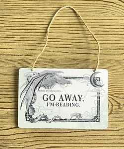 Owlcrate dragon reading sign