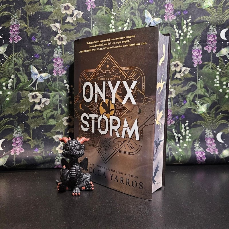 Onyx Storm  **Deluxe Edition** with a dragon statue 