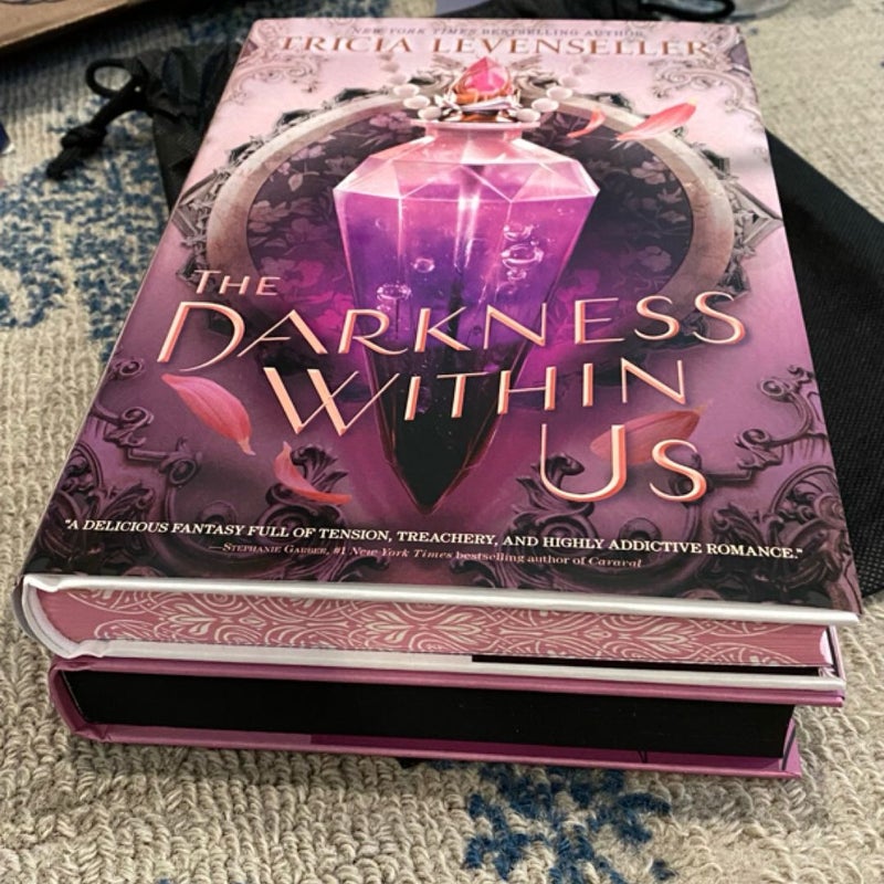 The Darkness Within Us Fairyloot book & water bottle and the First Edition book