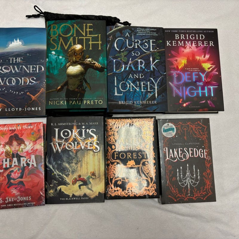 Box with 15 books and 20 goodies from Bookish box, Illumicrate, Fairyloot, Faecrate and Owlcrate.