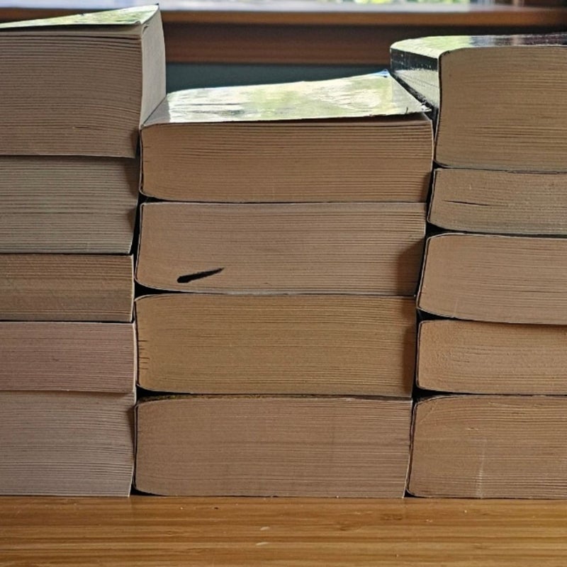 Assortment of 14 paperback fantasy novels by Jude Fisher, Laura Resnick, Robert Jordan, and C. J. Cherryh.