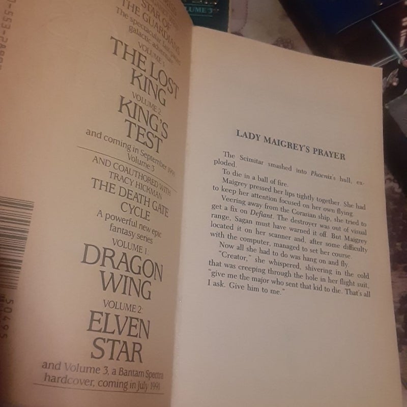 Complete Star of the Guardians trilogy by Margaret Weis, all mass market paperbacks. Books 2 & 3 have creased covers & creased / broken spines. Book 1 in good shape
1 The Lost King, 
2 King's Test,
3 King's Sacrifice - has a date stamped on top.