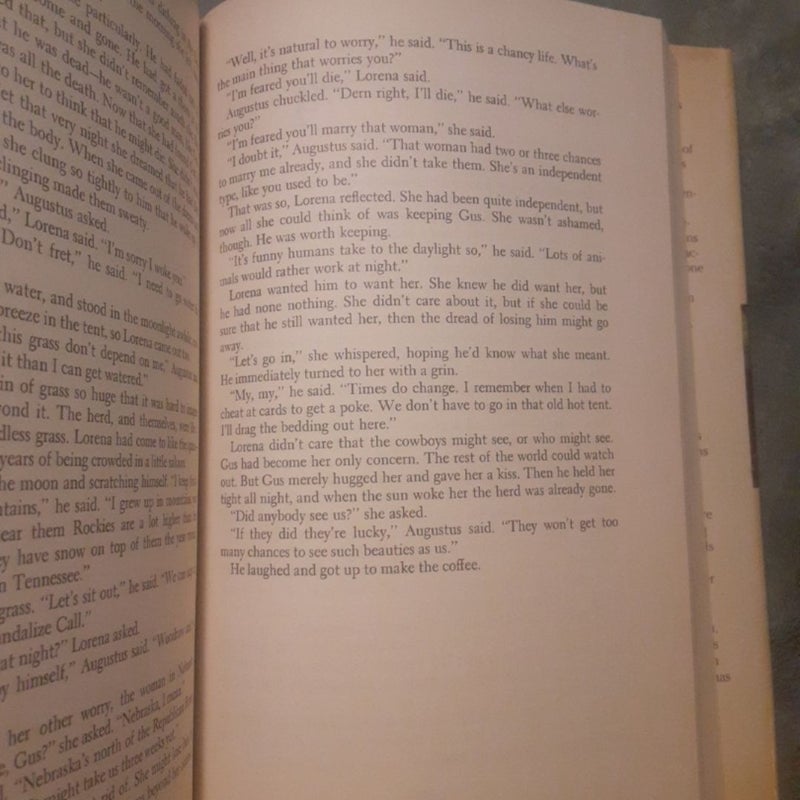 2 Hardcover Books By Larry McMurtry! Both with dust jackets. =0

~ Lonesome Dove : 2nd printing, with the page 621 typo Error! Book has some reading wear & age spots on top. In good shape.

~ Comanche Moon : 1st printing, some shelf wear & sticker remains on DJ. Pencil inscription on 1st page, in very good shape