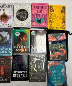 Box with 12 books and 30 goodies from Bookish box, Illumicrate,  Fairyloot, Faecrate and Owlcrate. 