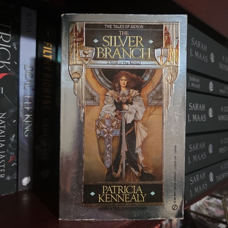 Thomas Canty, cubierta de The Silver Branch de Patricia Kennealy, mujer pelirroja sentada con espada y escudo dentro de un marco ornamental